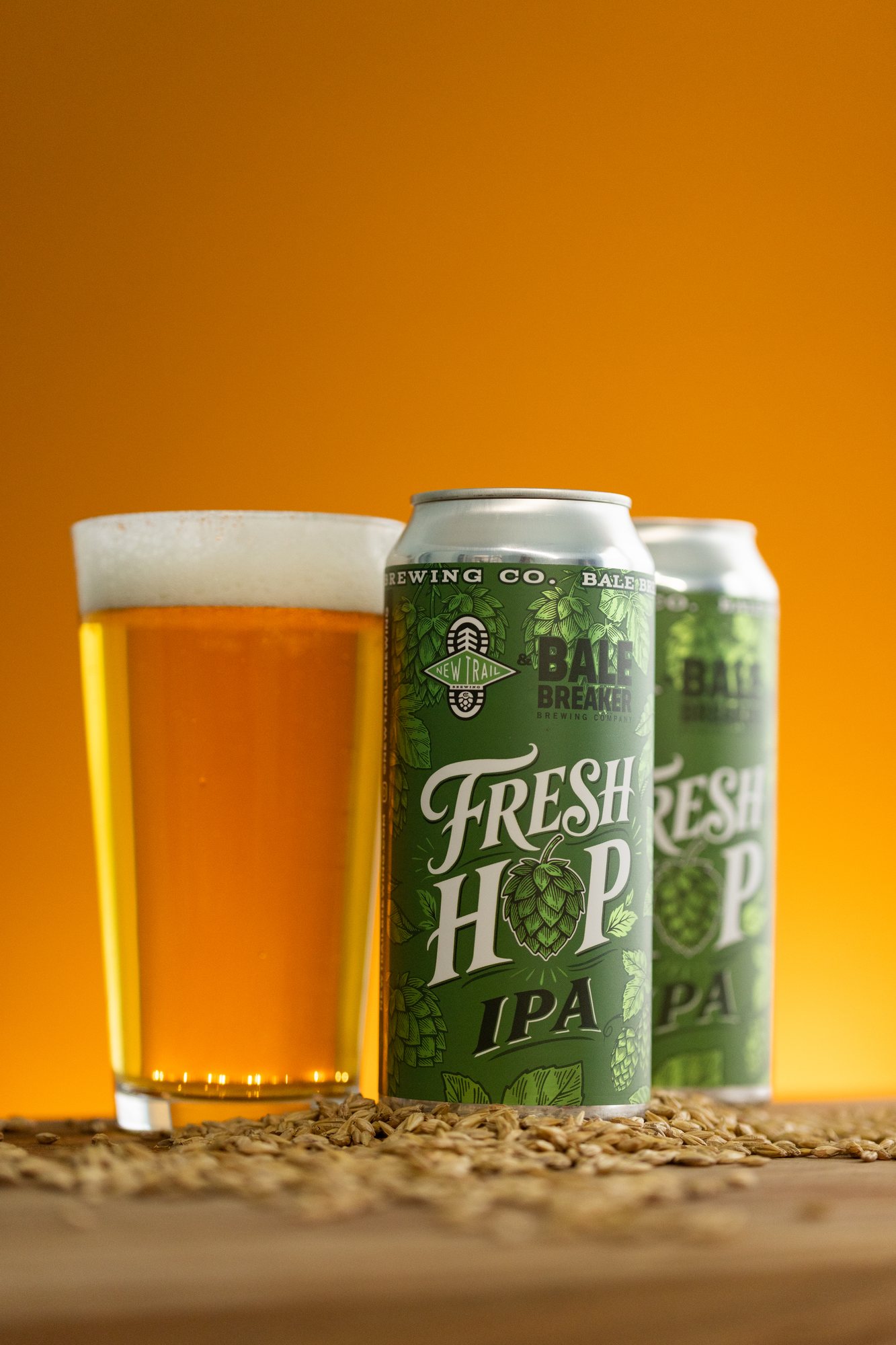 Fresh Hops IPA cans beside a poured glass