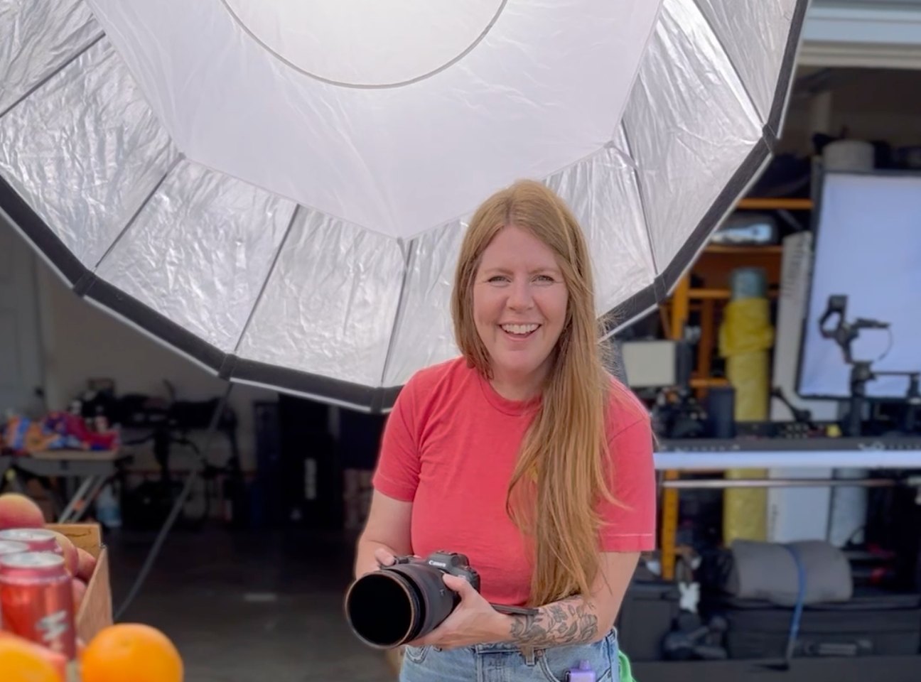 Kristen with the camera beside the blood orange stand