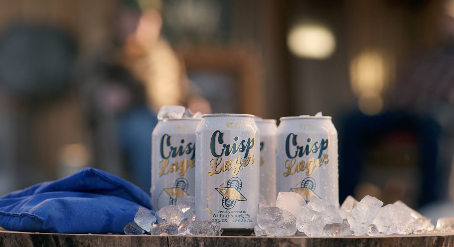 Crisp Lager cans lined up on ice