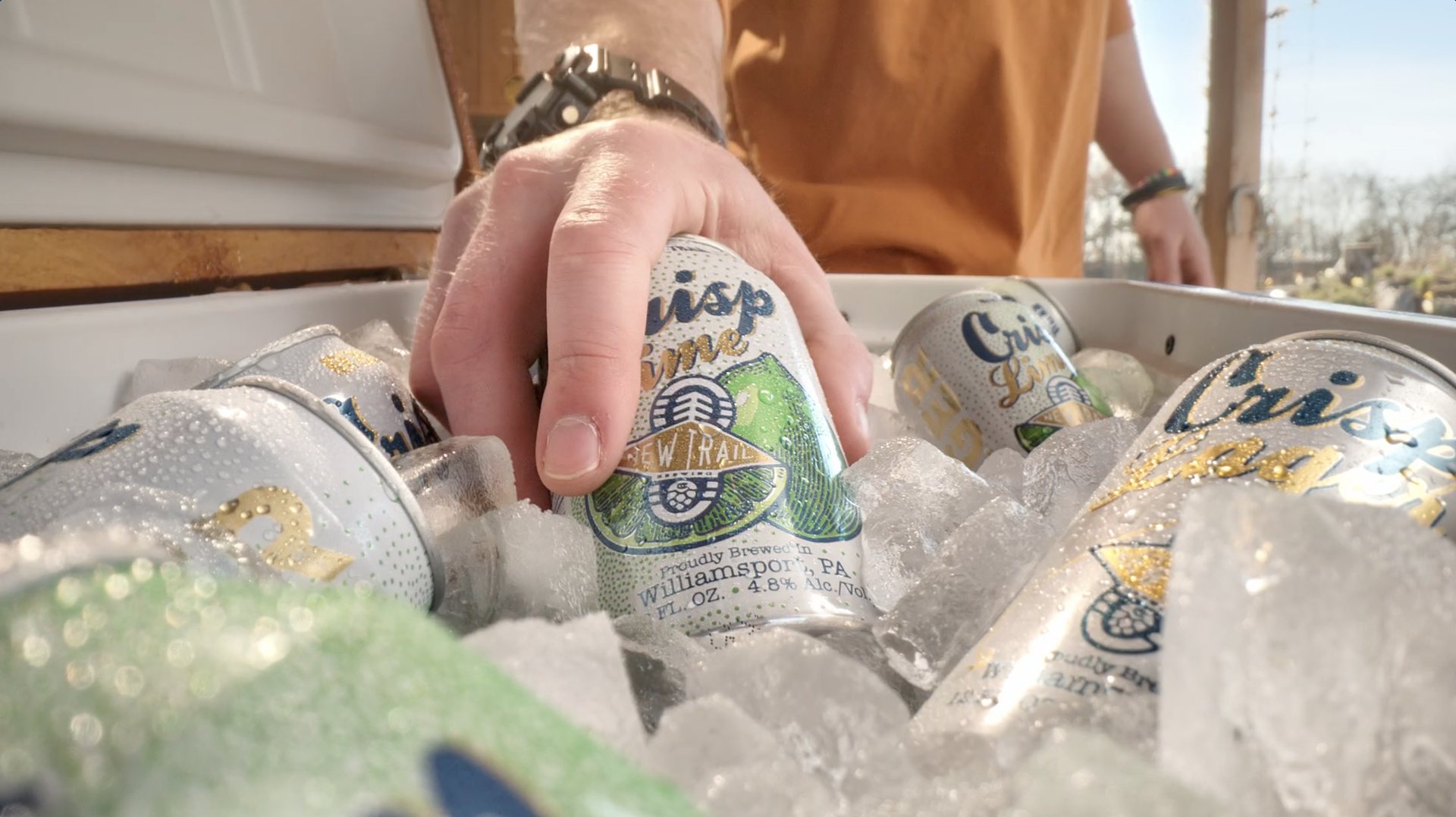 Crisp Lime cans on ice in a cooler