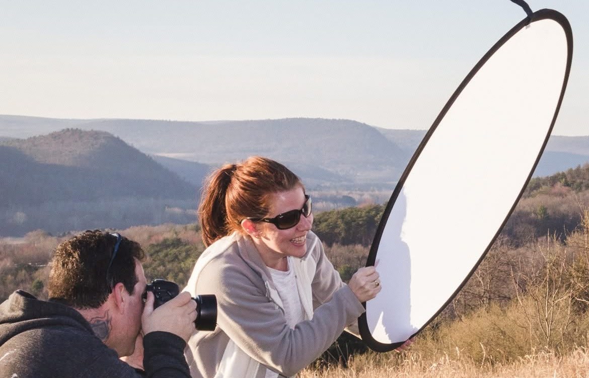 Holding a reflector on a mountaintop portrait shoot in the early days