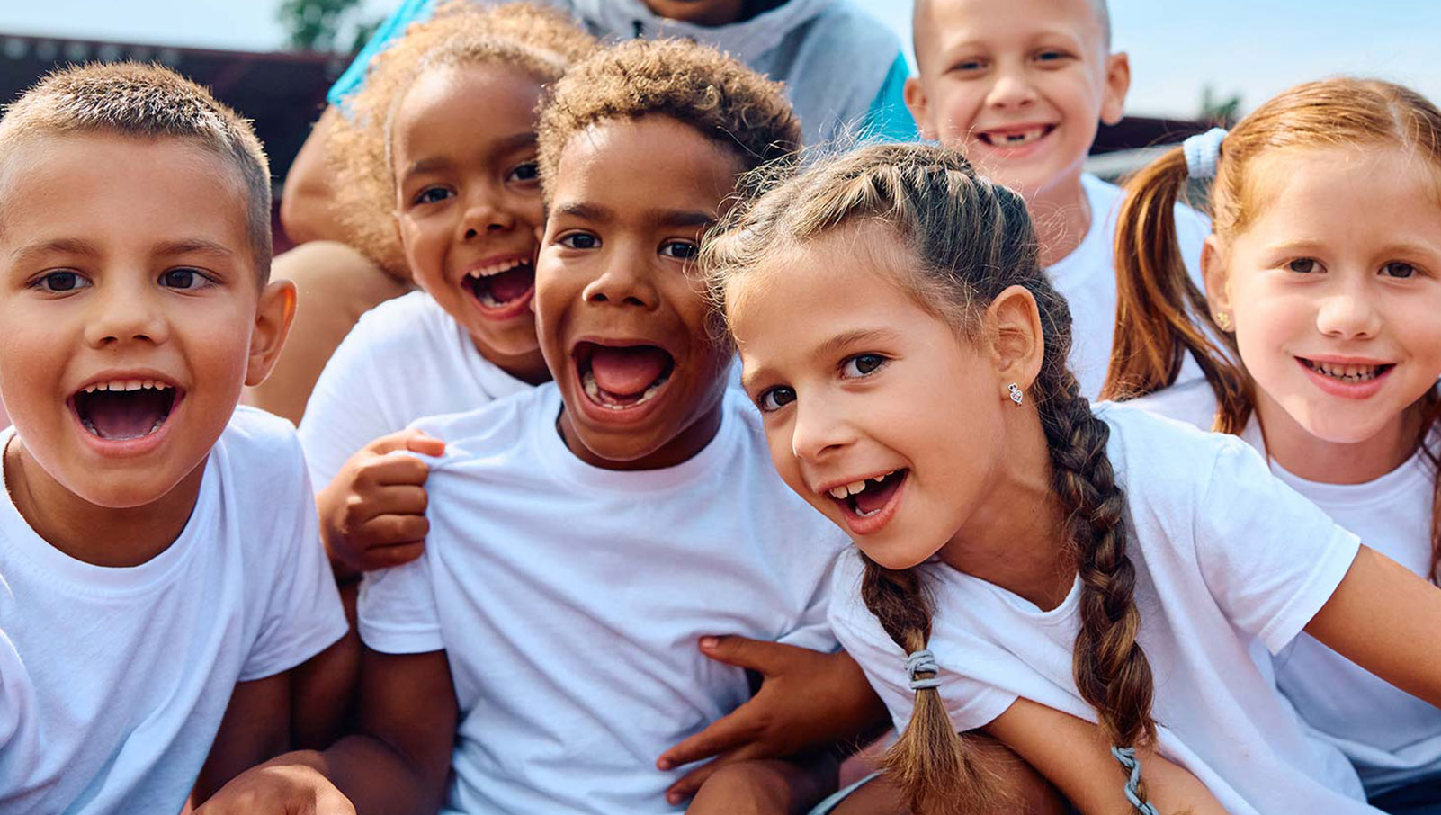 Photo of a group of children, happy, smiling, celebrating life.