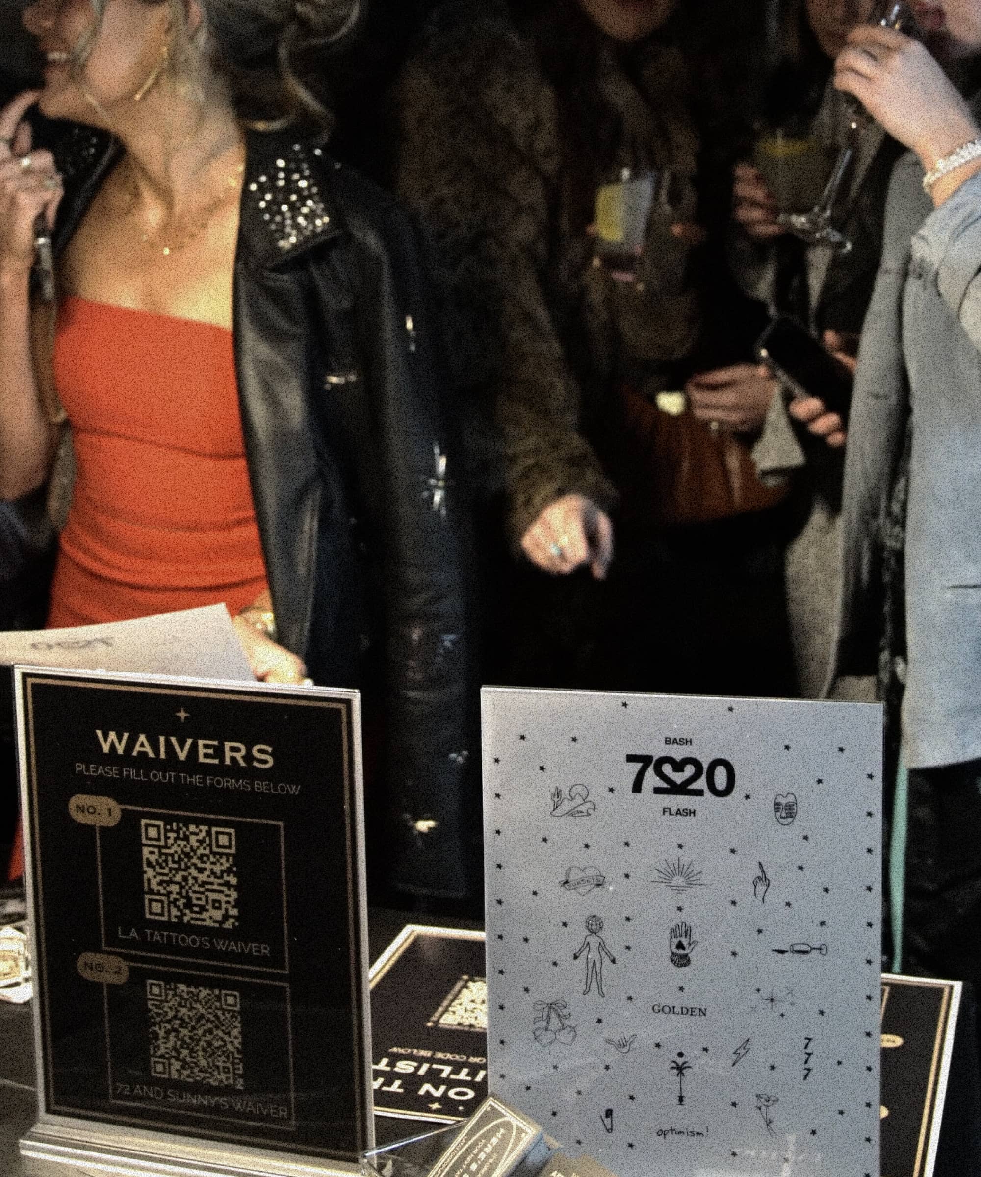 Event table with waiver QR codes and a flash tattoo design sheet labeled 720 Bash and Golden.