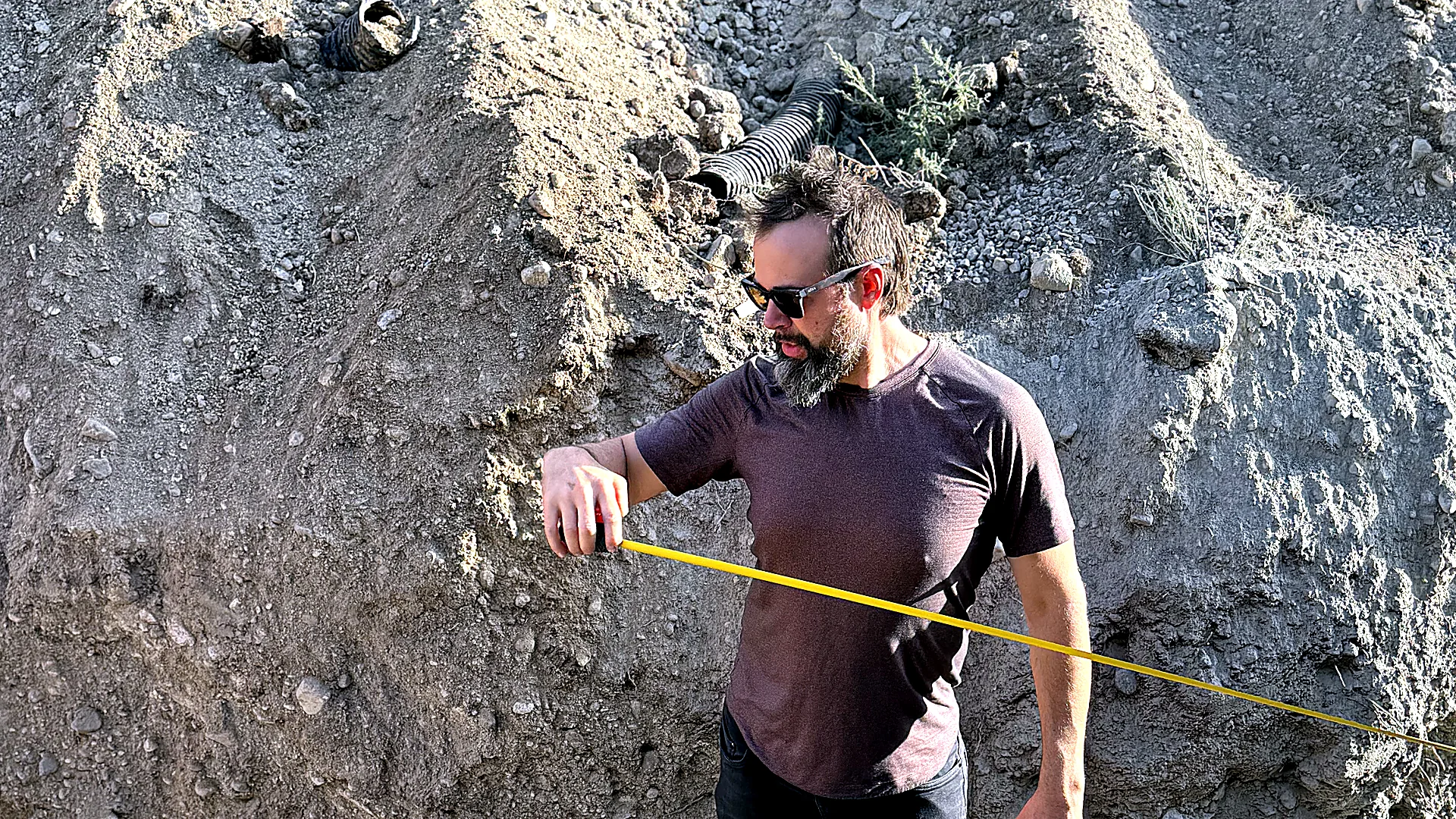 Real estate site measurement tape — Chris Curry measuring the boundary at 2104 SW 14th Street, Gainesville Florida