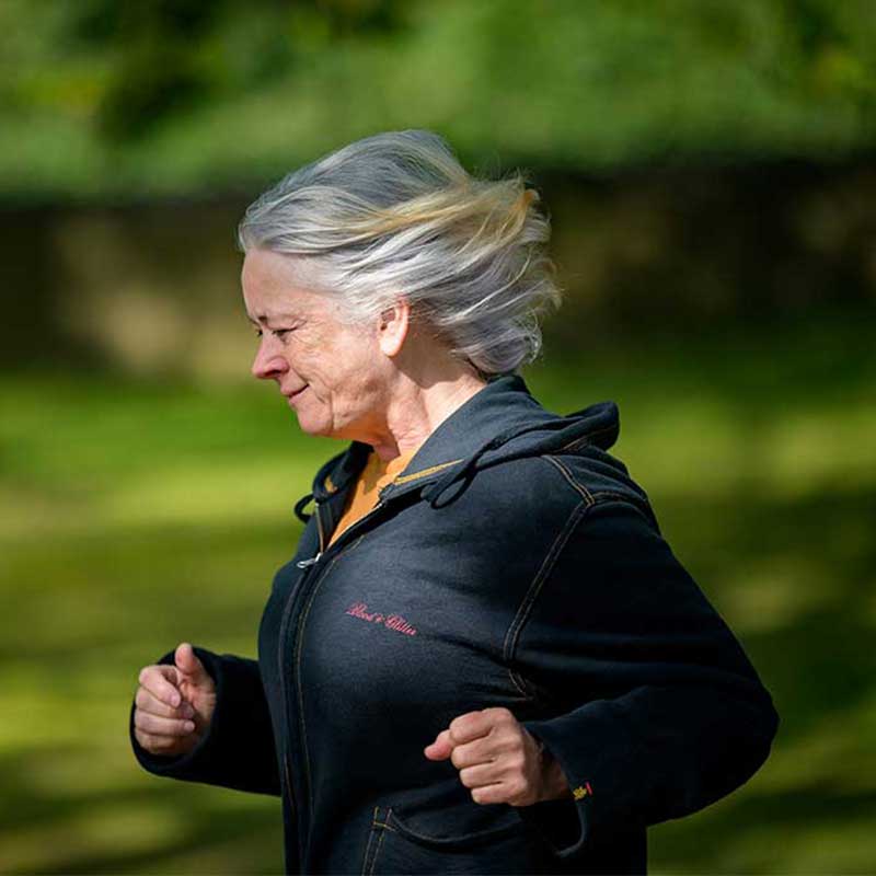 Older woman jogging outdoors in a park