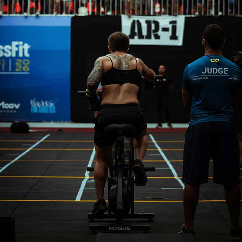 Athlete on an assault bike during a CrossFit competition