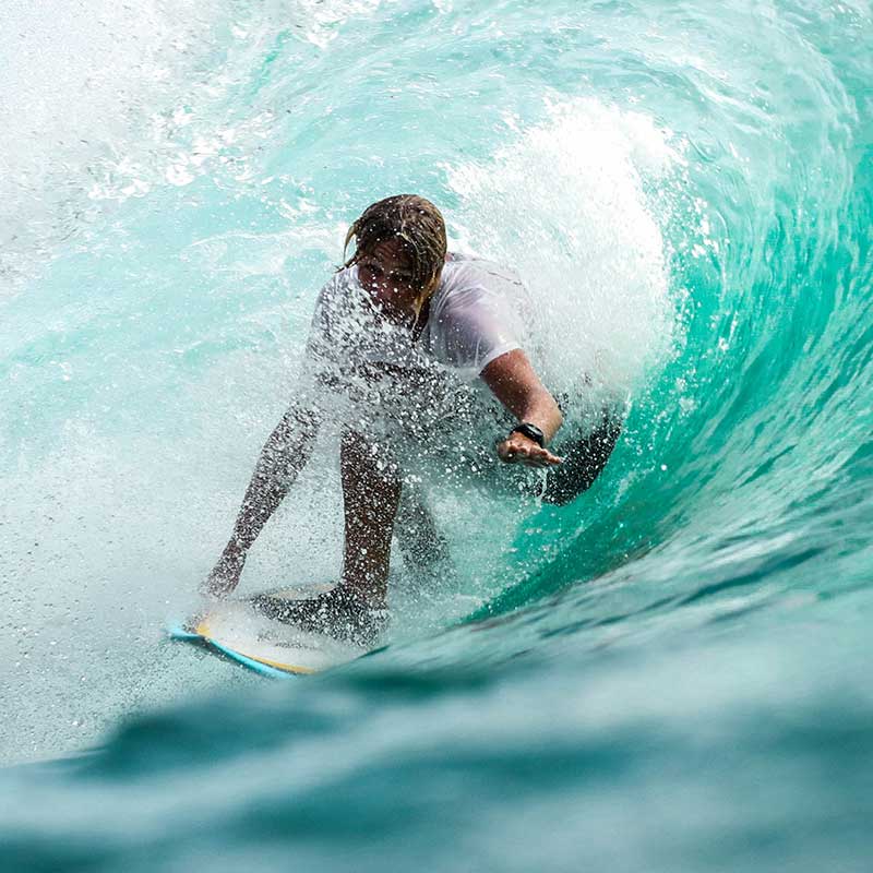 Surfer riding inside the barrel of a wave