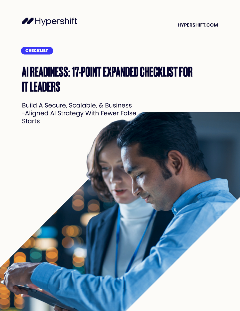 Two professionals reviewing information on a tablet with blurred city lights in the background, illustrating IT leaders working on AI readiness.