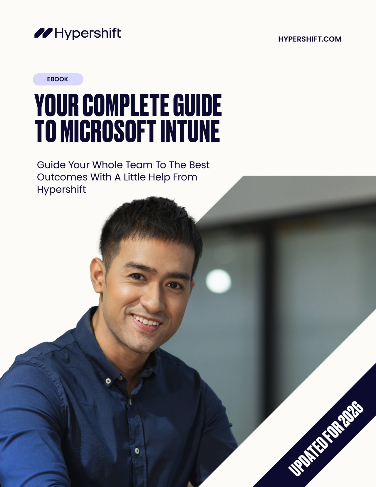 Cover of an eBook titled 'Your Complete Guide to Microsoft Intune' with a smiling man in a blue shirt and text noting it is updated for 2026.