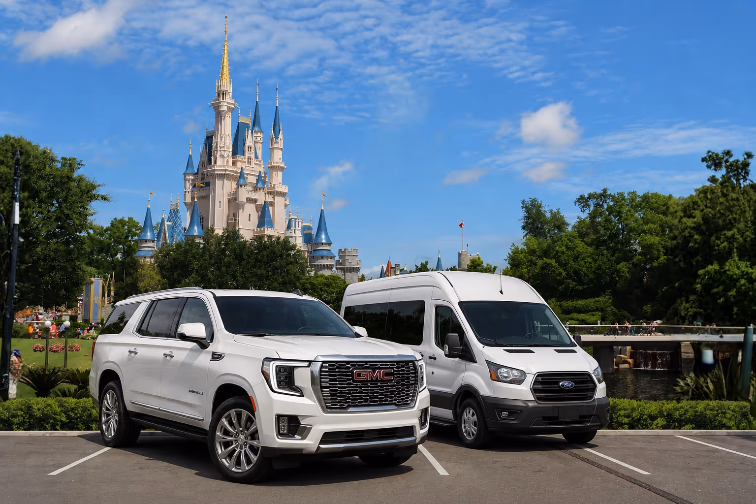 White GMC Yukon SUV and white Ford Transit van parked by Walt Disney World Castle and trees in the background under blue sky.