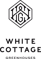 White Cottage company logo featuring a white house with a pitched roof and a door.