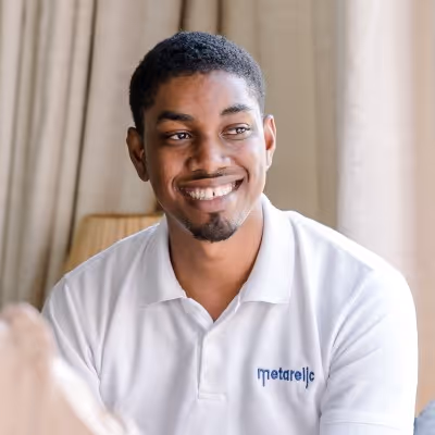 Clevon Smiling, wearing a white Metarello polo shirt.