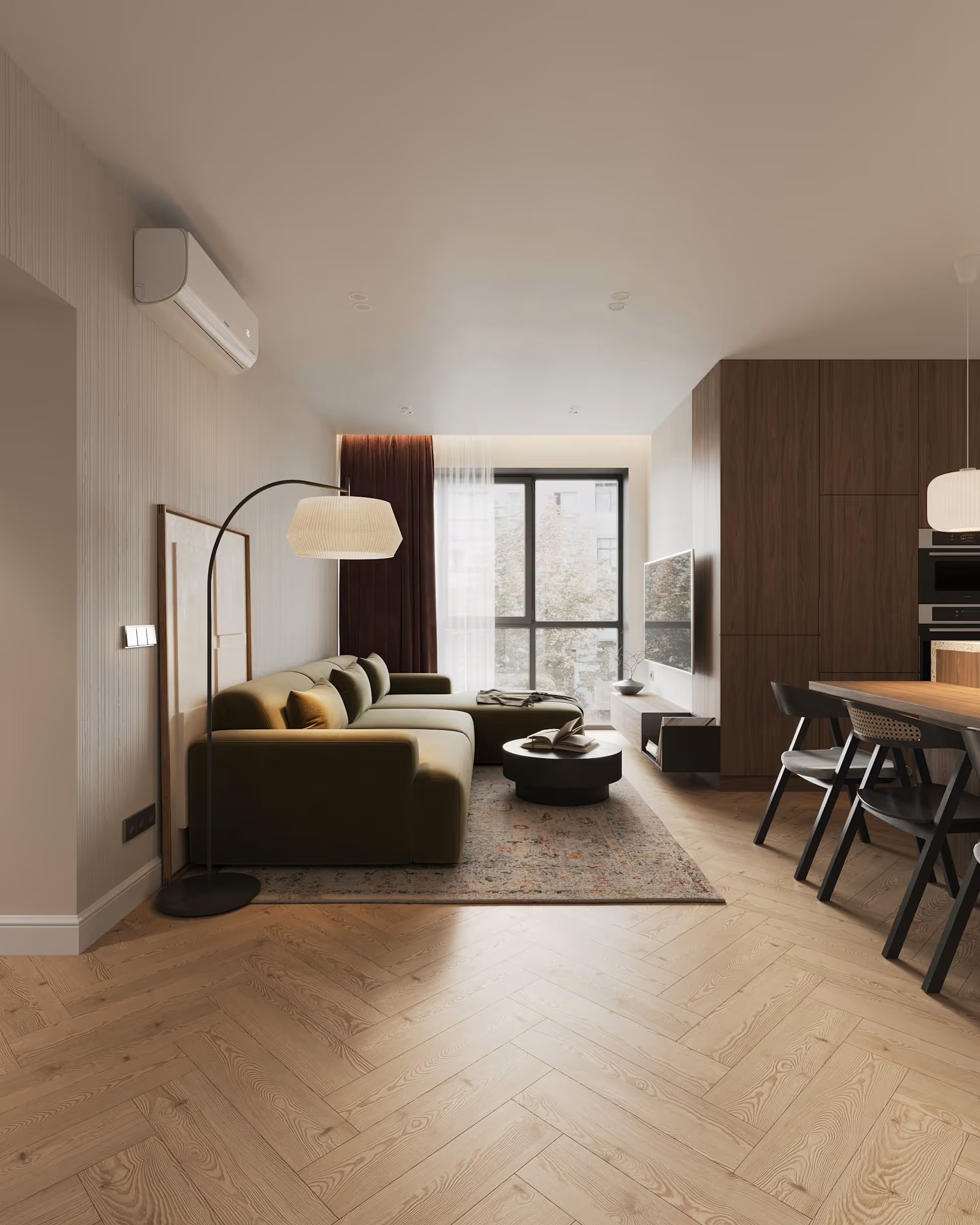 Modern living room with green sectional sofa, floor lamp, rug, wall-mounted TV, and wooden dining chairs.