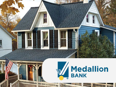 Two-story house with blue siding and gray roof, featuring Medallion Bank logo