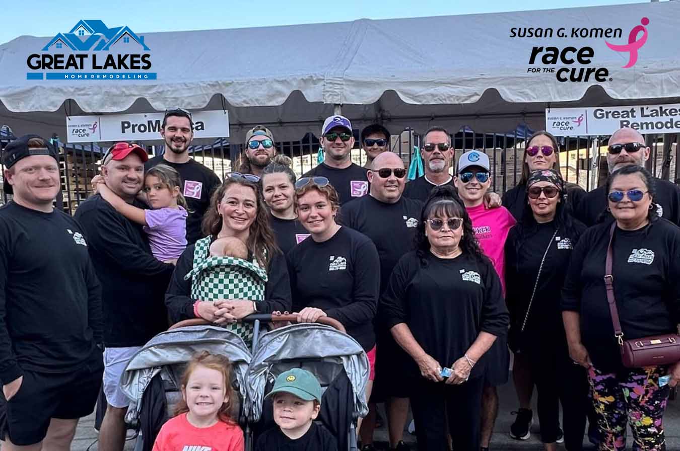 Group in matching black shirts in front of the Great Lakes Home Remodeling tent at the 2025 Komen Race for the Cure in Toledo