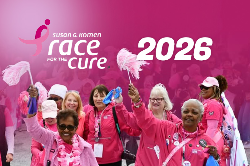 Participants in pink jackets cheering and waving pink pom-poms beside the Susan G. Komen Race for the Cure 2026 logo