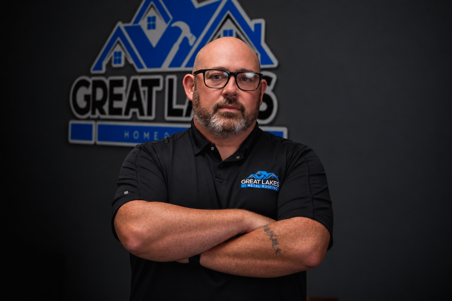 Doug Farr, founder and CEO of Great Lakes Home Remodeling, standing in front of the company logo