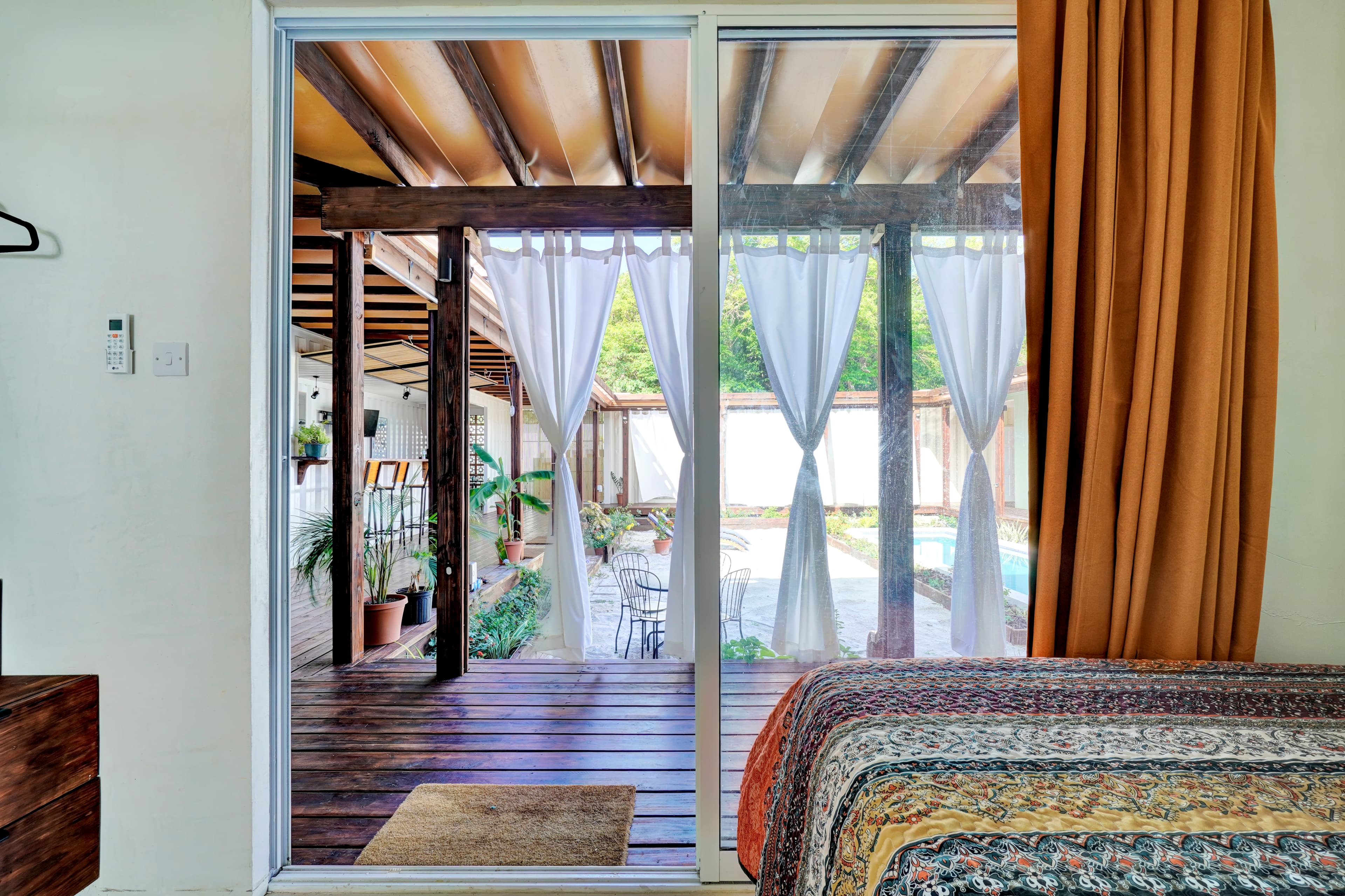 Corten Villa bedroom opening to pool