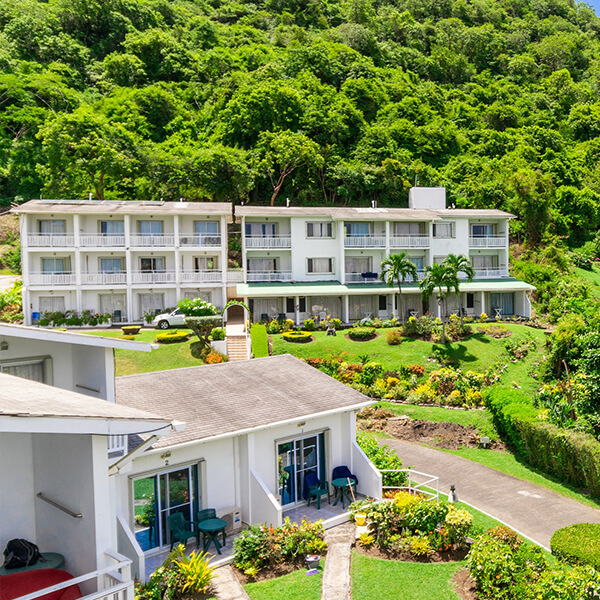 Siesta Hotel exterior and landscaped hillside gardens in Morne Rouge