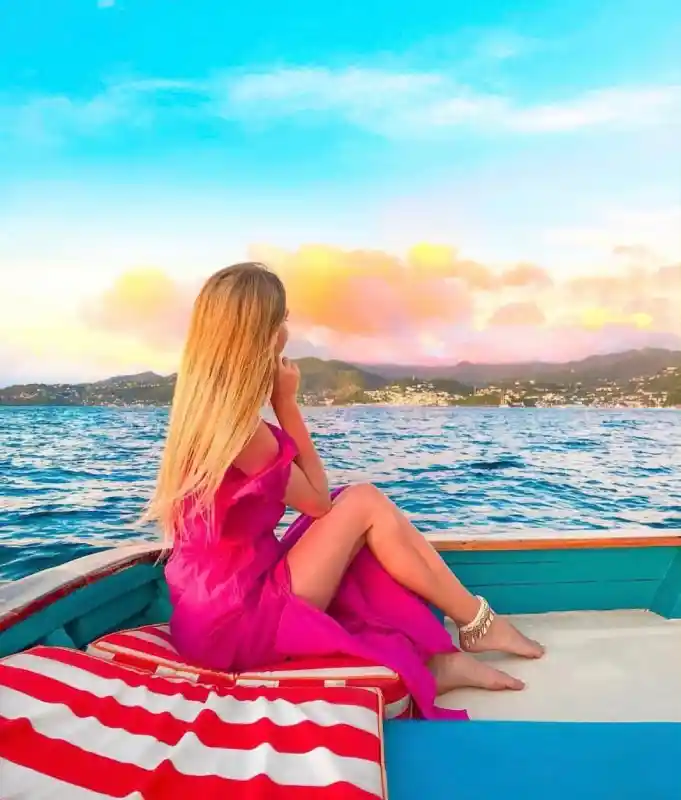 Guest relaxing aboard Savvy Sailing at sunset in Grenada