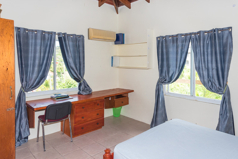 Alternate angle of a furnished bedroom and desk in the Mateo's apartment complex