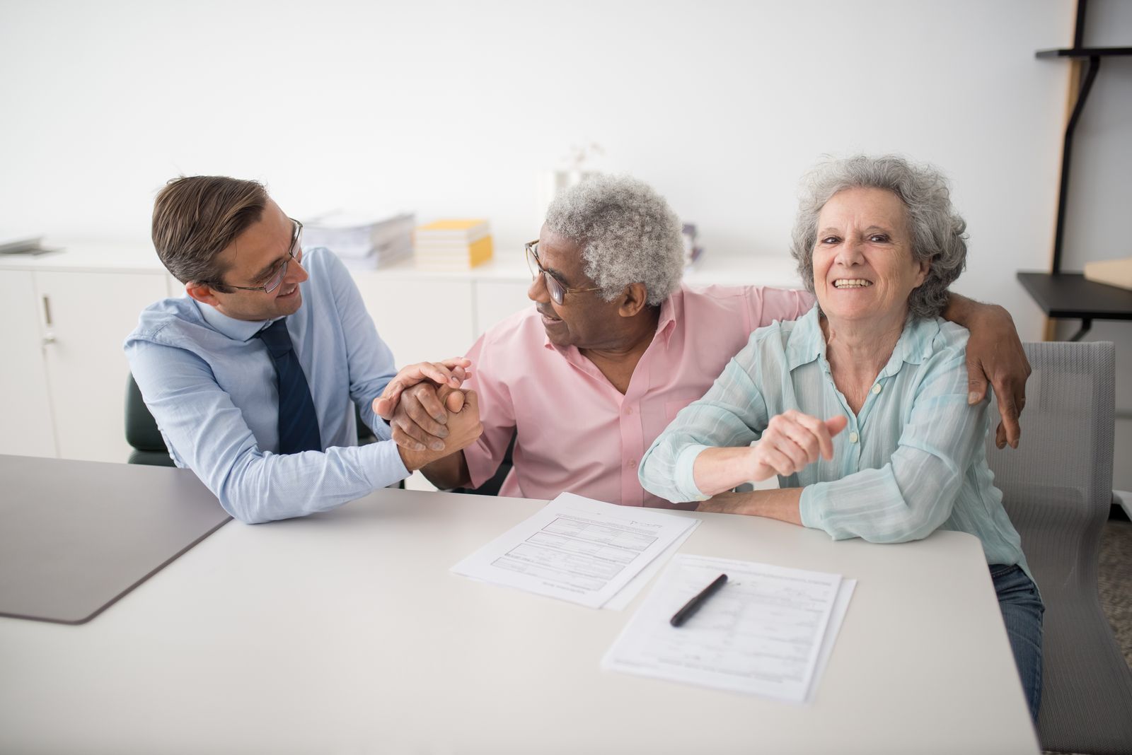 An older couple meeting warmly with an advisor about care planning