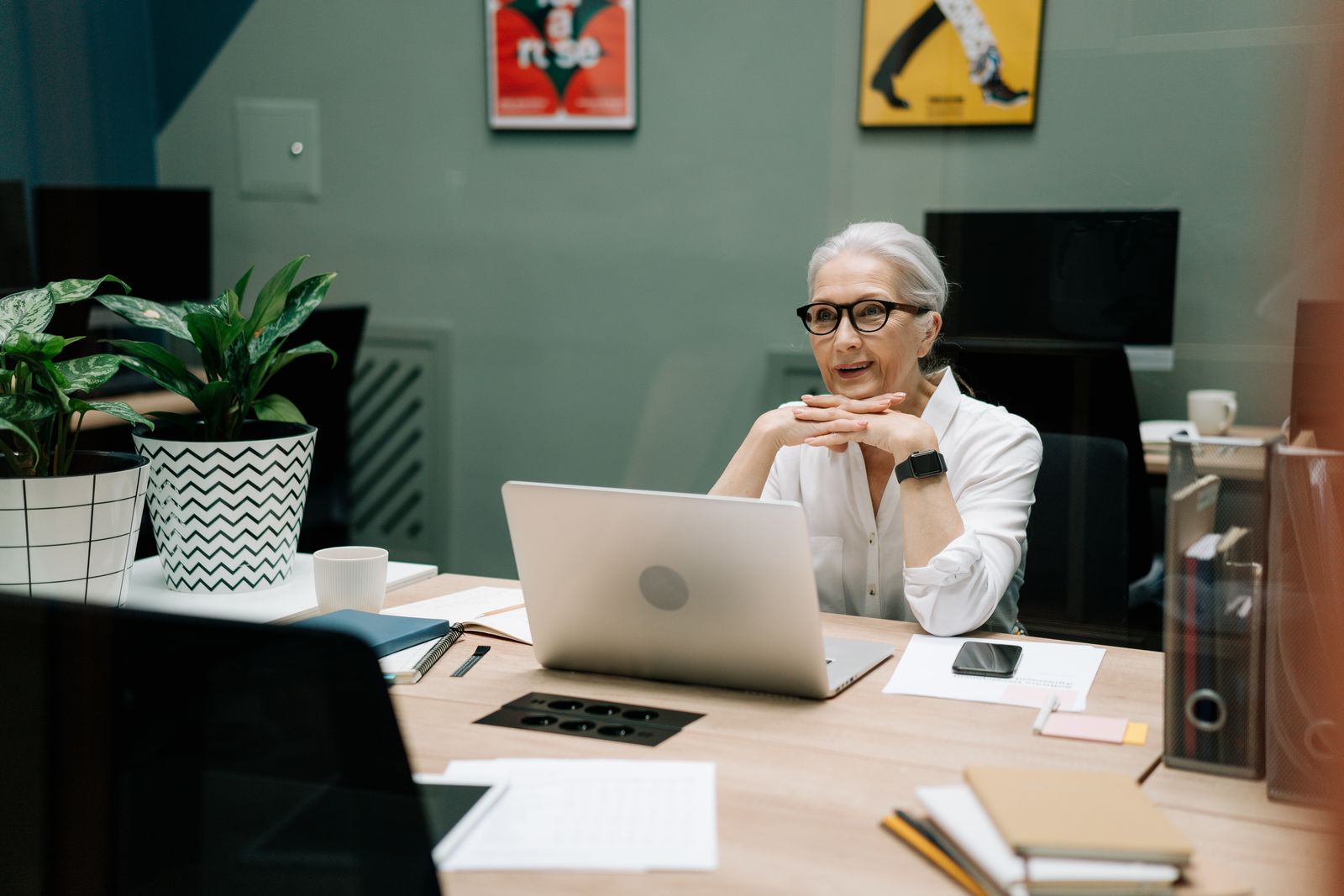 A mature professional working at her office desk