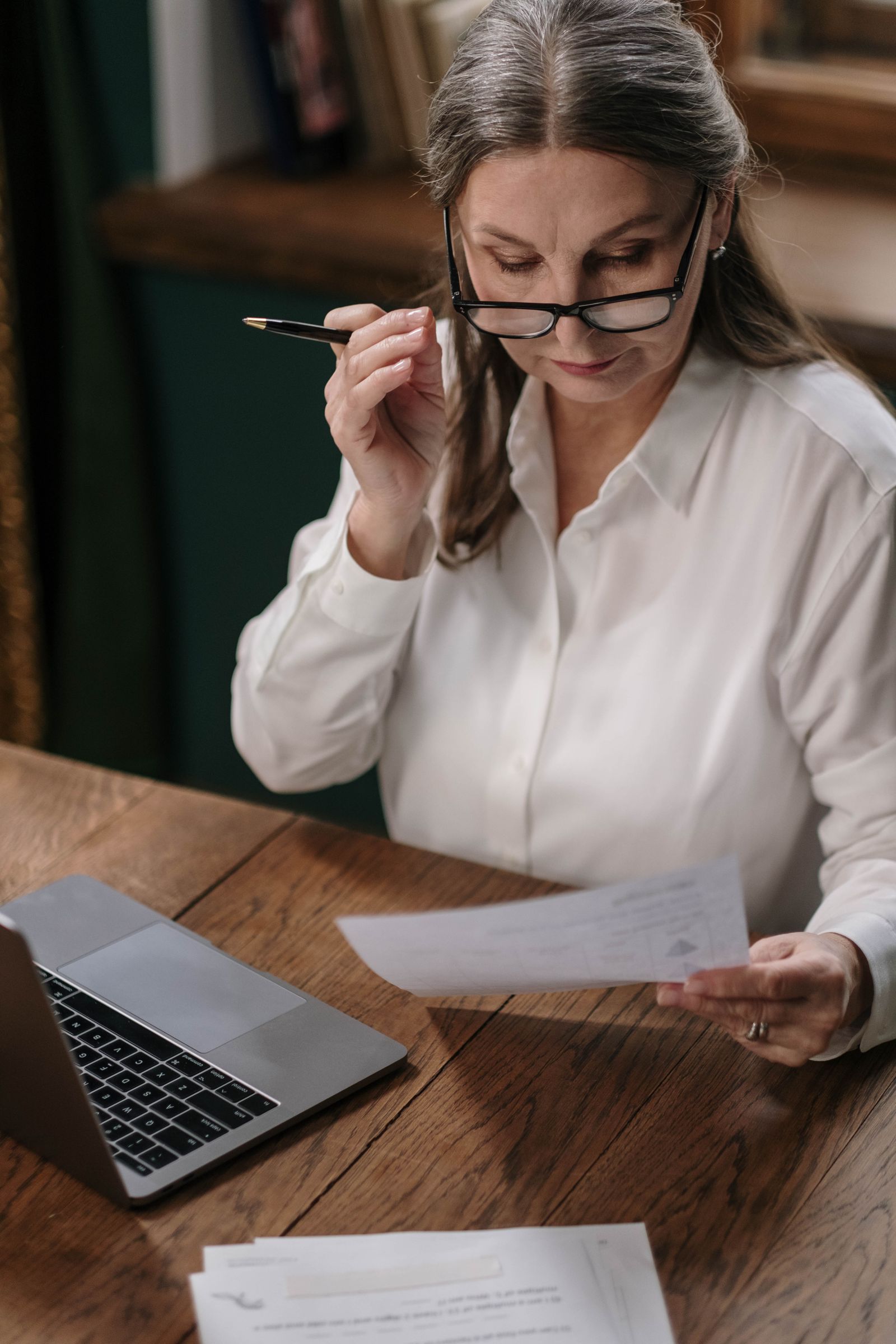 A woman reviewing insurance documents at her desk