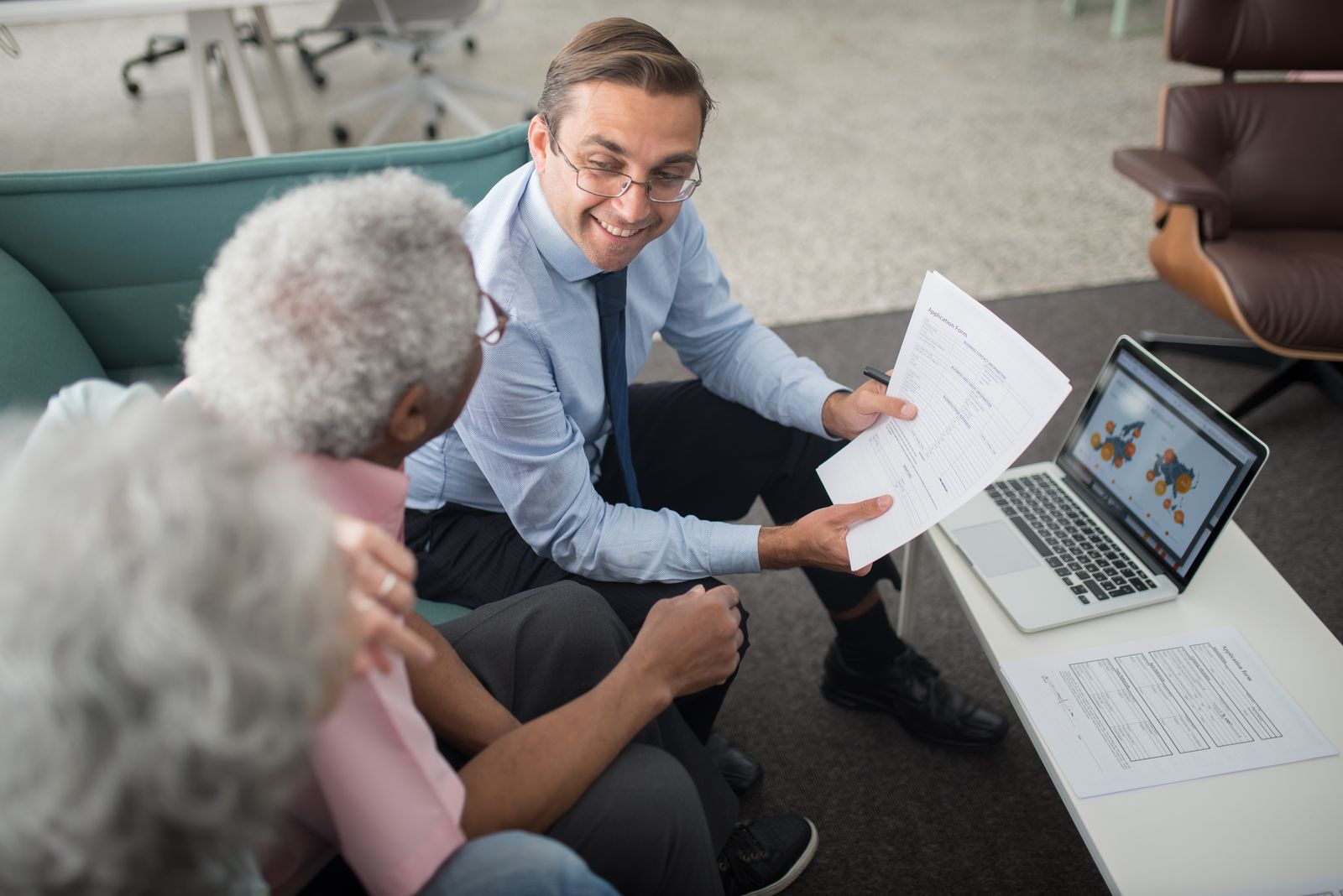 An advisor explaining Medicare options to an older couple