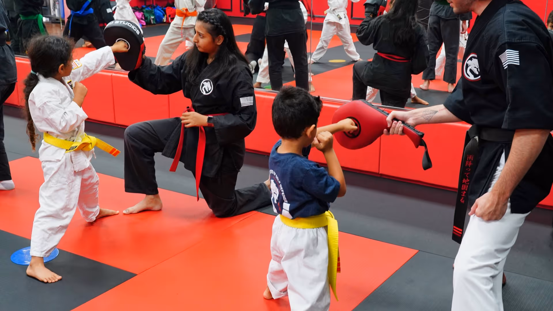 Karate instructor adjusting a student's punch 