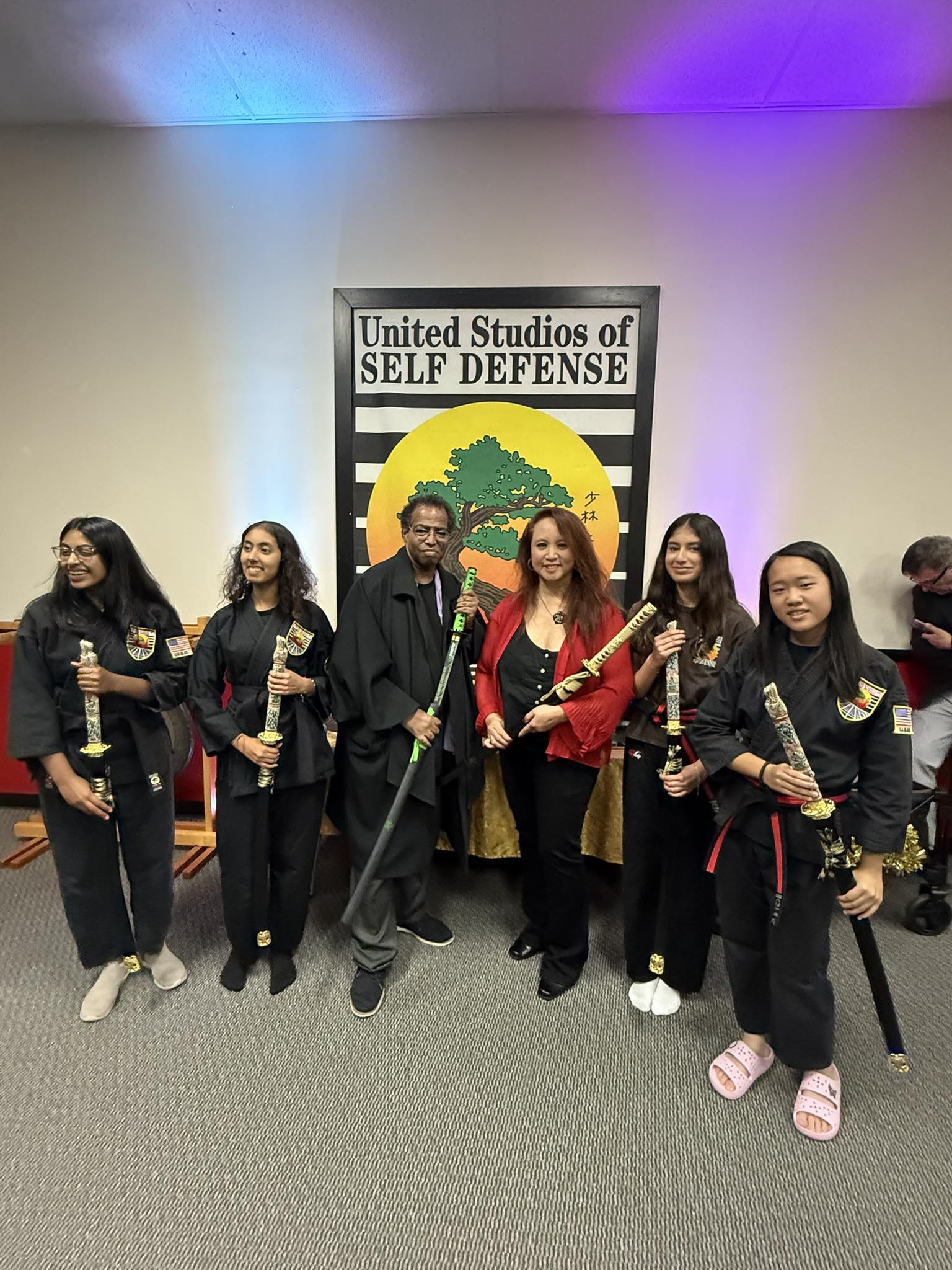 Beginner Karate students stand in a tight row, ready for class to begin.