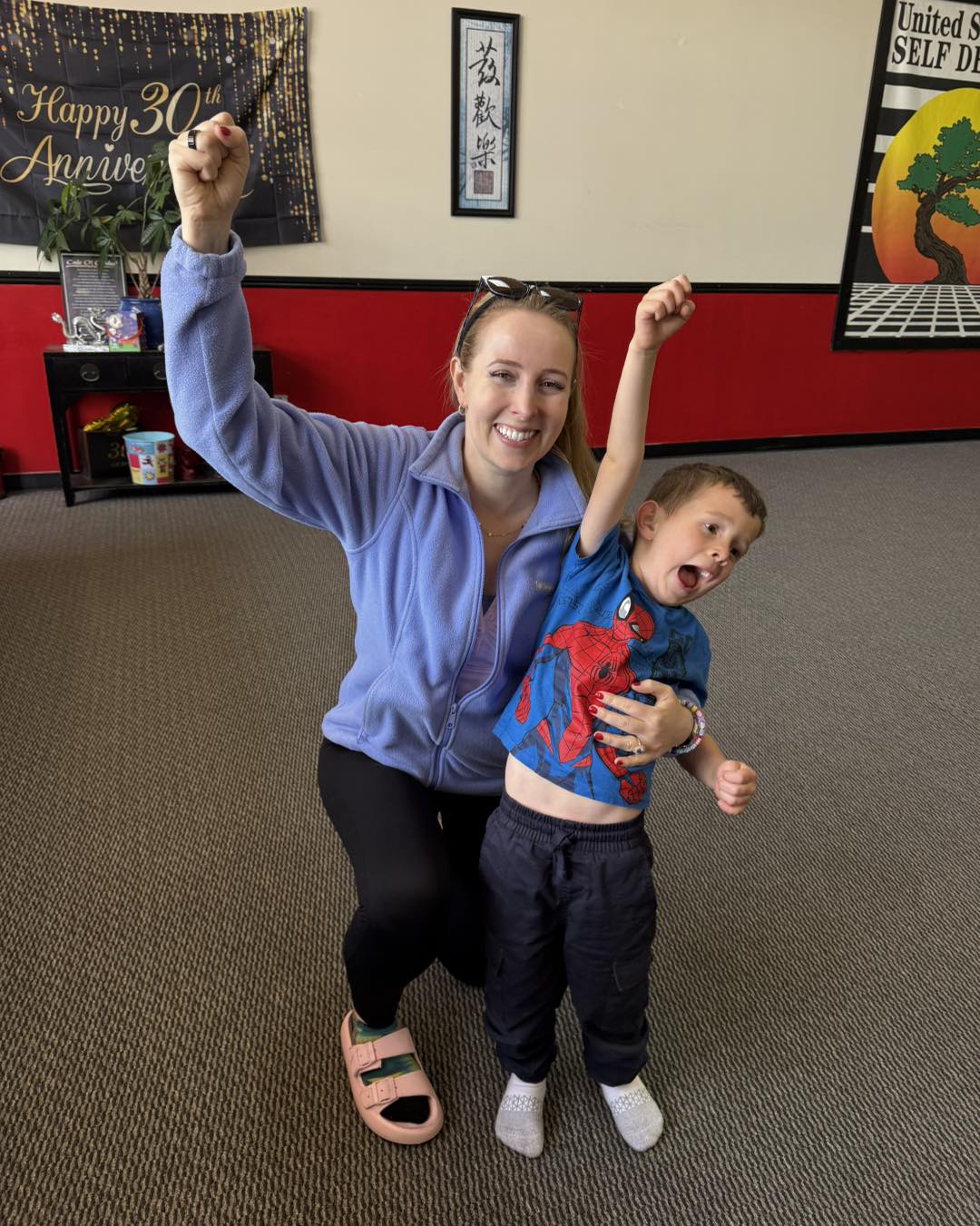 Karate instructor adjusting a student's punch 