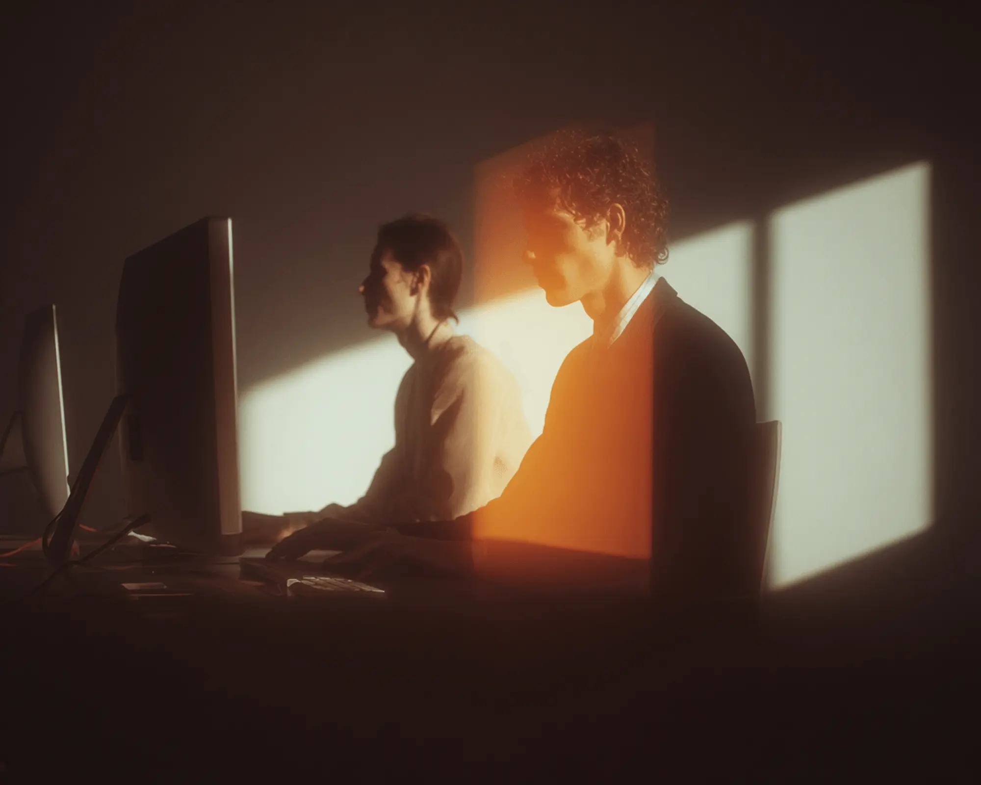A man and woman working at a desk