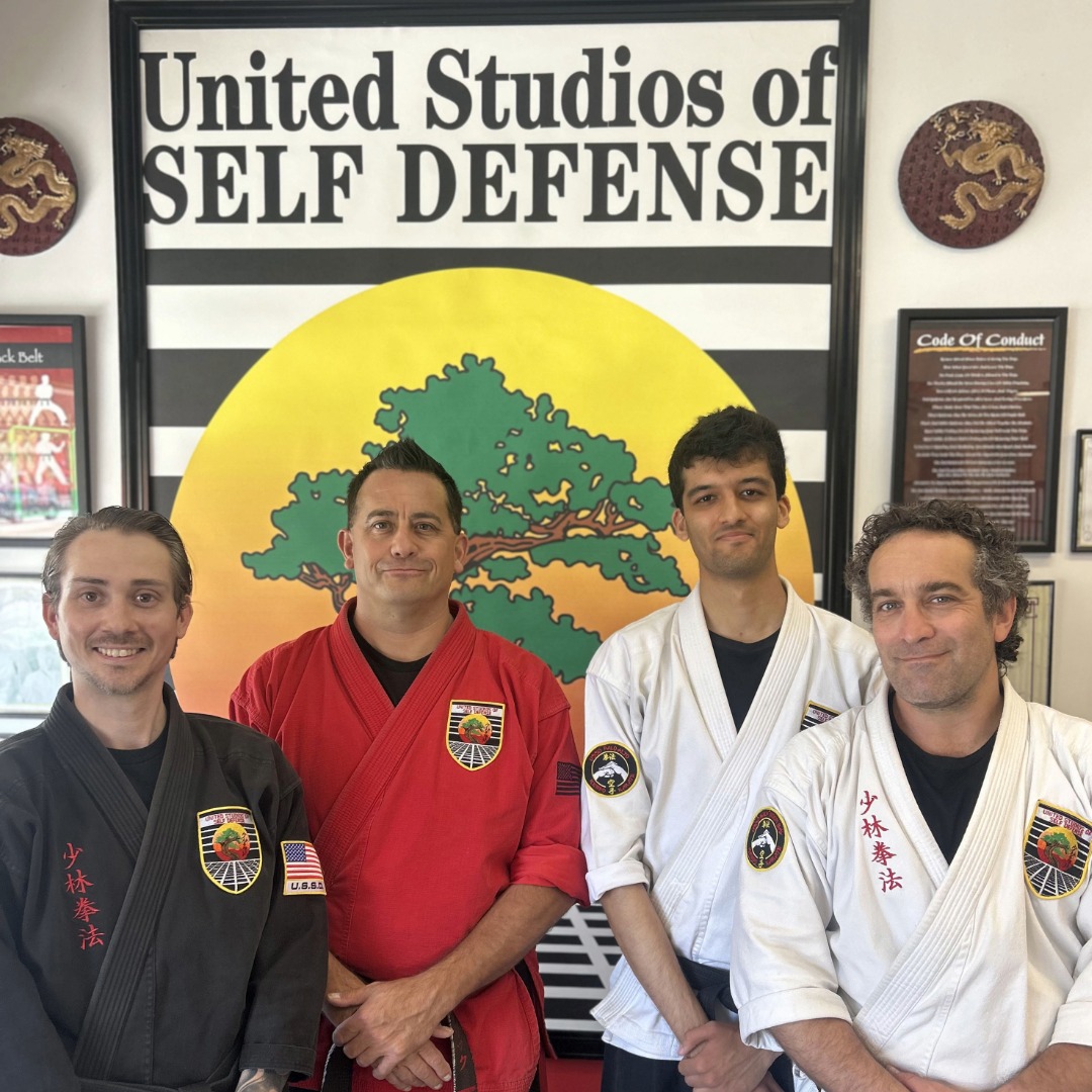 Beginner Karate students stand in a tight row, ready for class to begin.