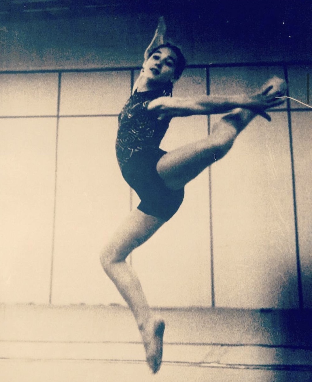 Rebeca Yagüe as a young rhythmic gymnast performing a back scale leg extension stretch