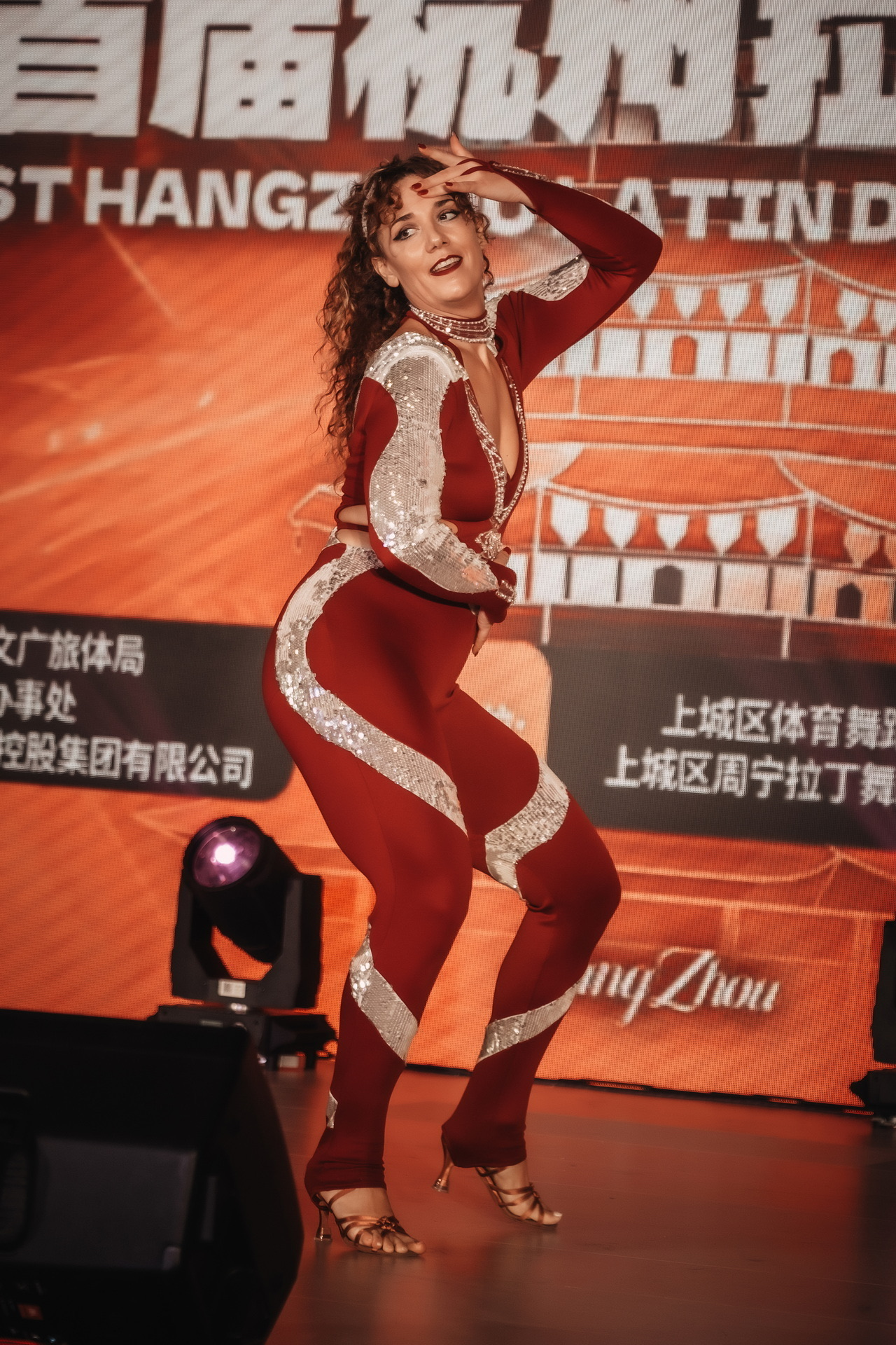 Rebeca Yagüe performing a solo bachata body movement routine on stage in Hangzhou