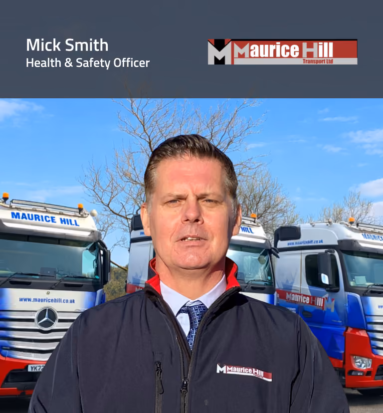 Mick Smith, Health and Safety Officer at Maurice Hill Transport Ltd, standing in front of the company’s fleet of trucks