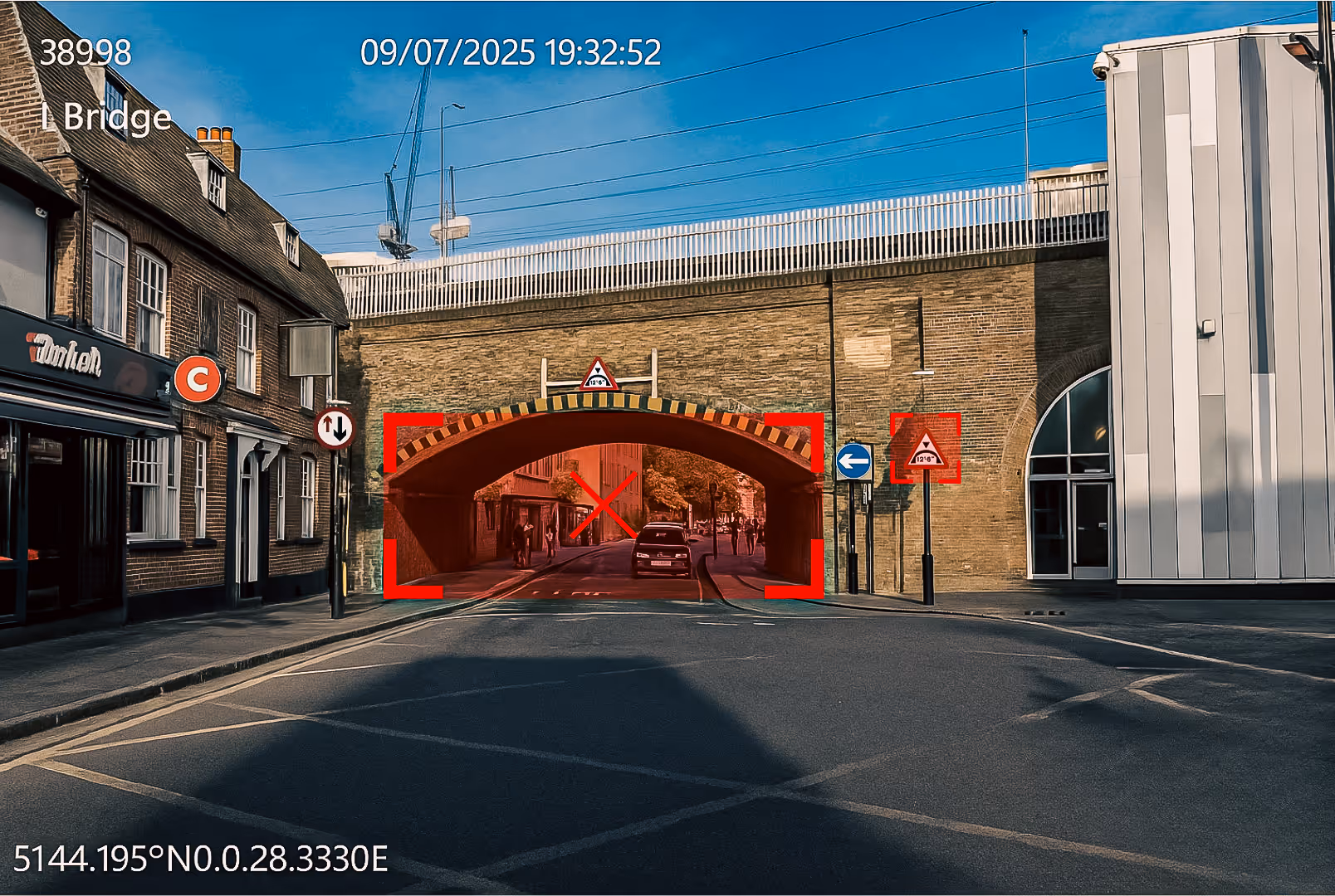 Exeros low-bridge collision prevention camera view highlighting a low railway bridge ahead with a red warning box