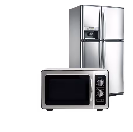Modern stainless steel refrigerator with water dispenser and silver microwave oven with dials.