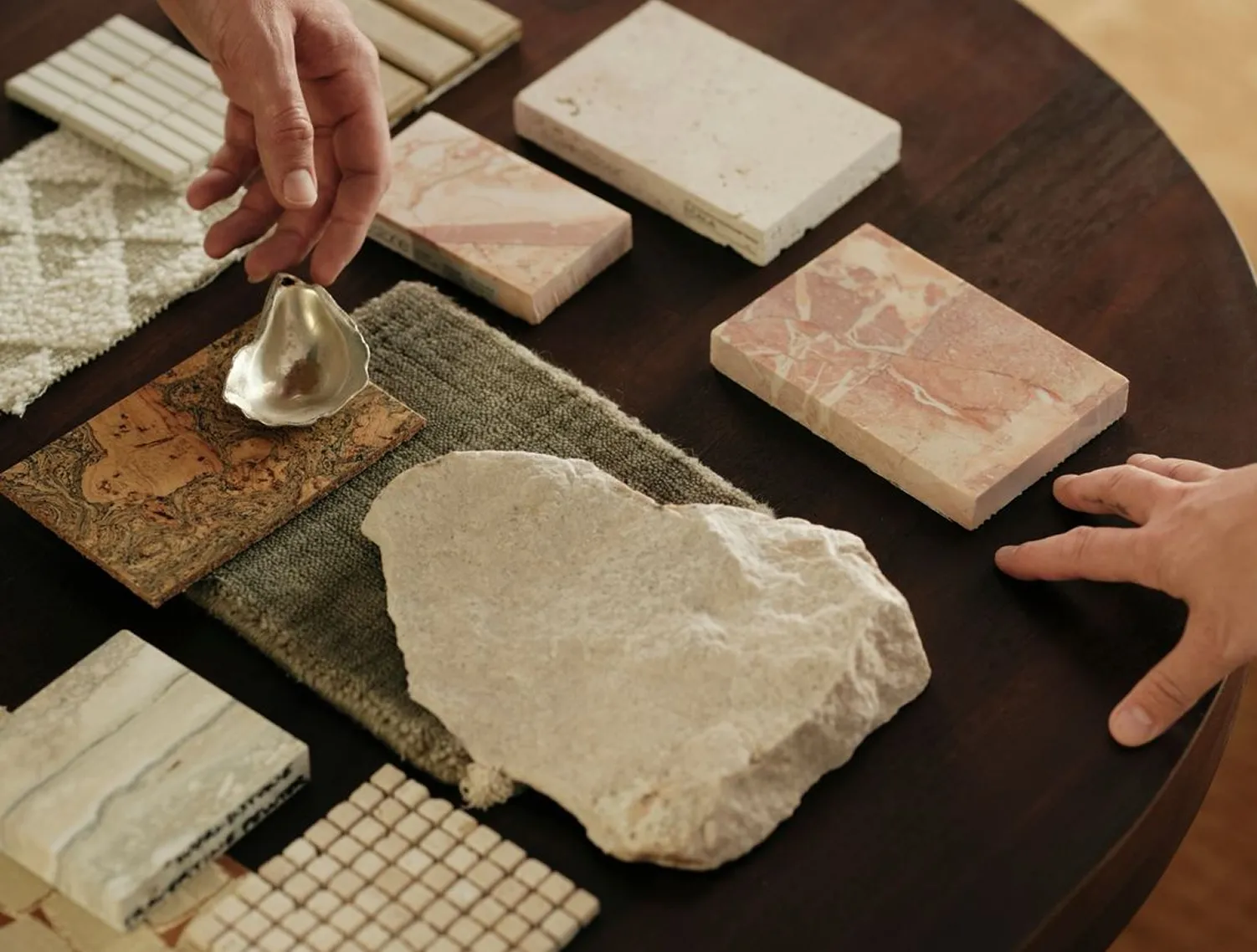 Marble and natural stone samples laid out on a table during material selection
