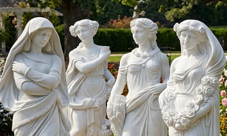 Four hand-carved white marble statues of women in a garden