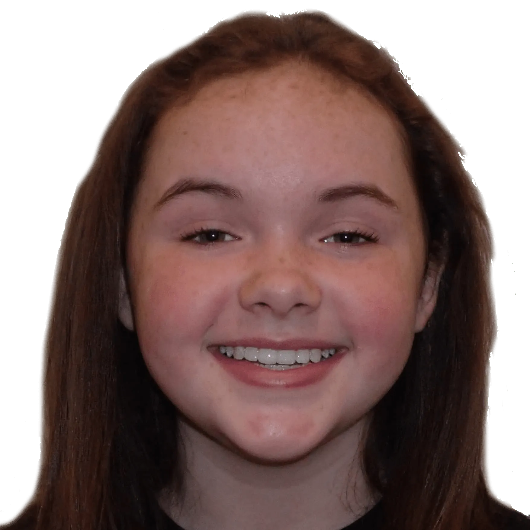 Smiling young girl with brown hair and freckles against a plain background.