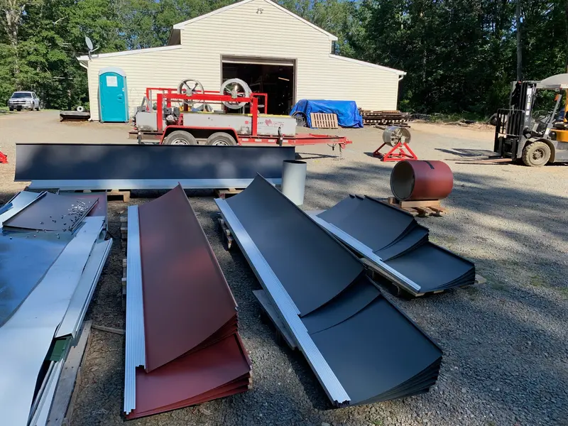 Standing seam metal panels, trim, and equipment staged together for a contractor order