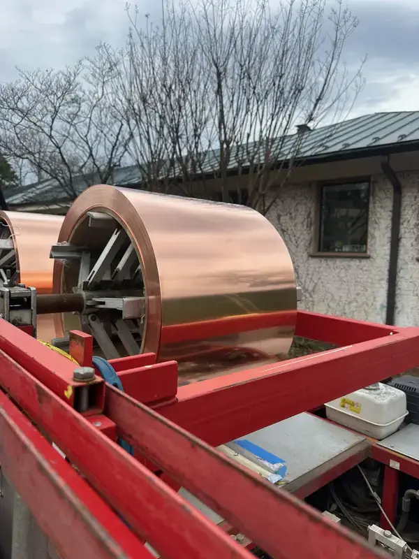 Copper roofing coil mounted on panel-forming equipment