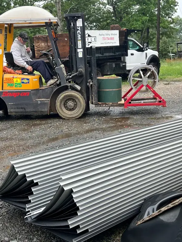 Custom-length standing seam roofing panels stacked and prepared for pickup
