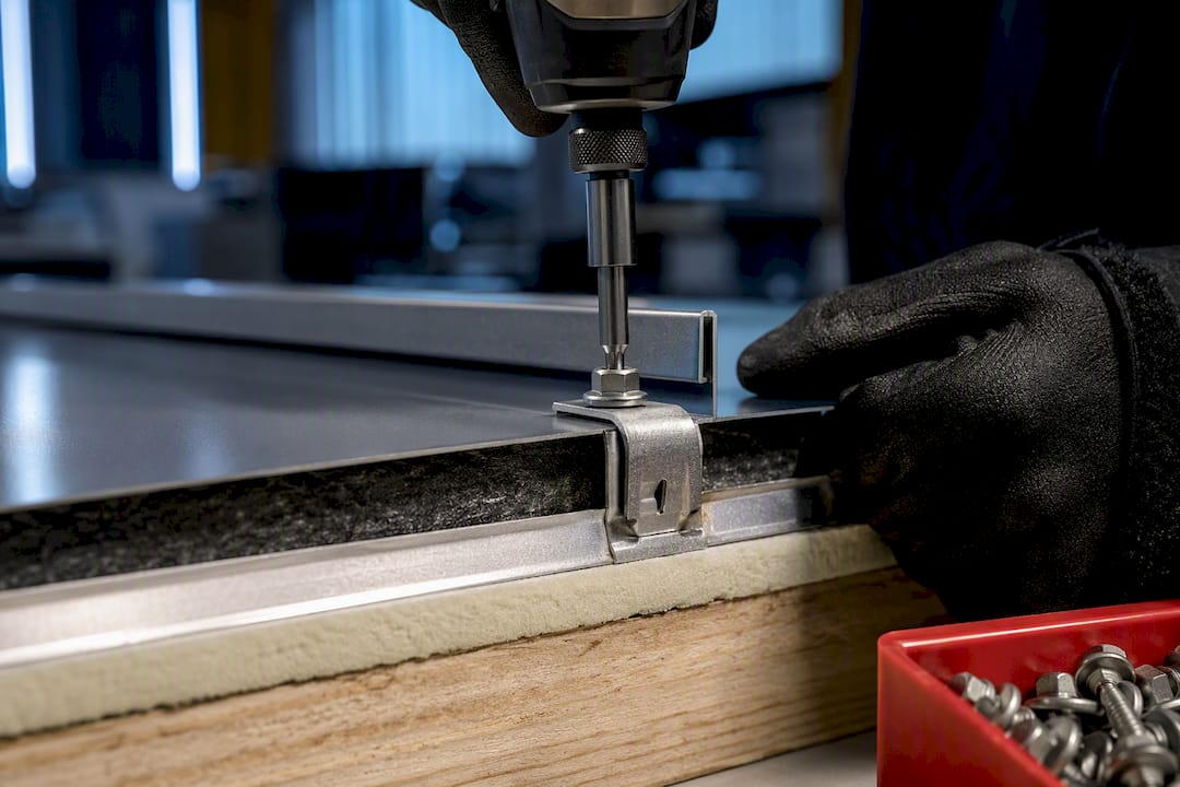Flanged bolt securing standing seam clip
