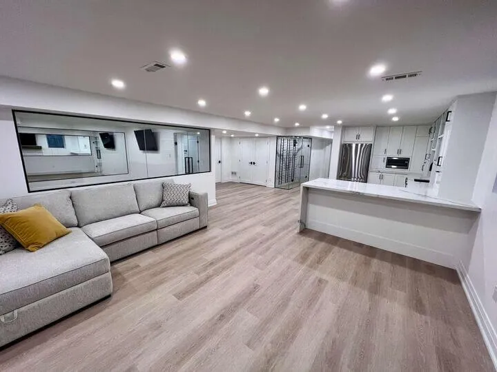 Finished basement living room with TV and electric fireplace