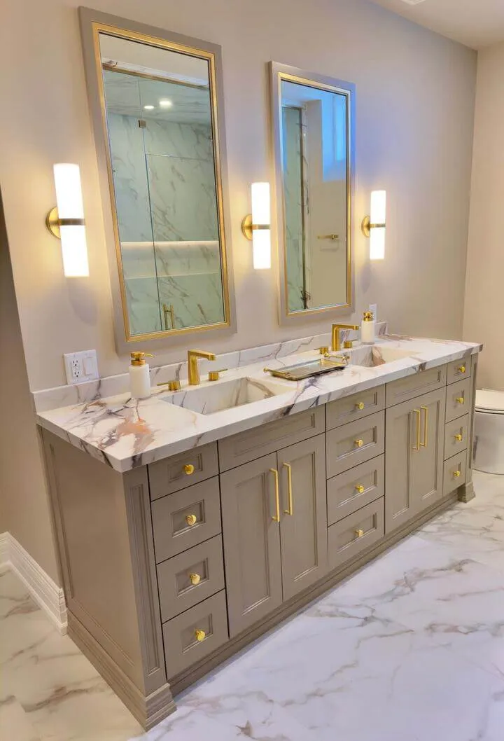 Basement bathroom with grey marble vanity and gold fixtures