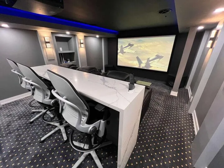Basement home theatre with white marble bar