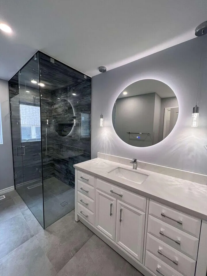 Basement bathroom with grey tile shower and modern vanity